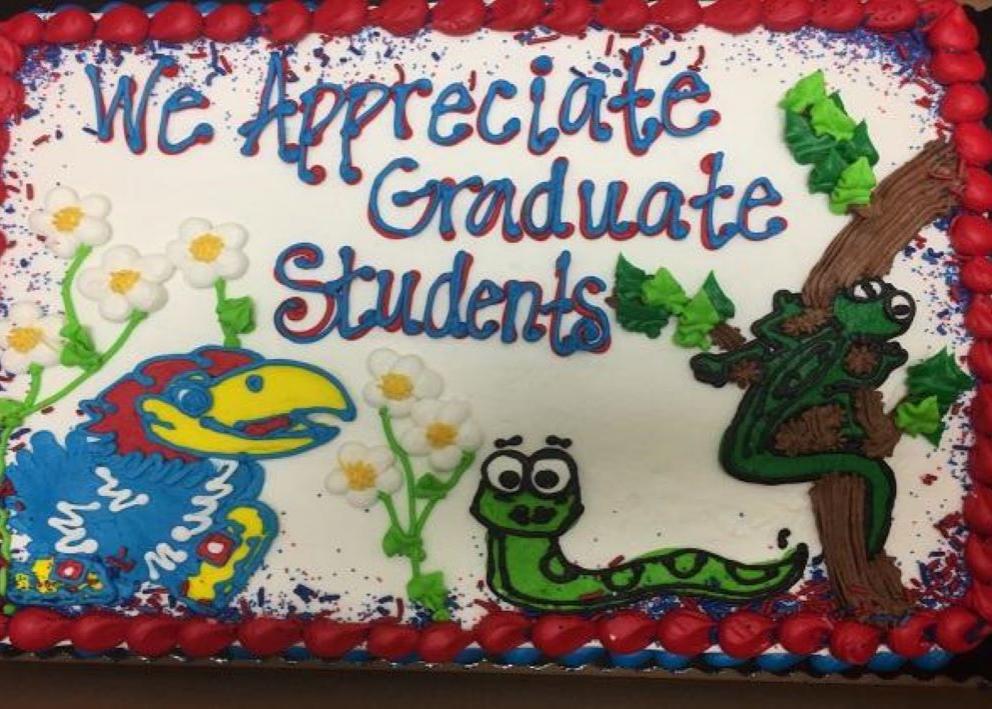 A cake with the KU Jayhawk as well as flora and fauna that says "EEB appreciates its graduate students"