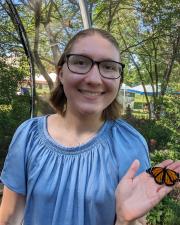 KU PhD student Cailin Kessen holding a butterfly