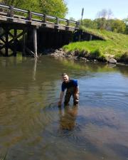 Profile picture of KU EEB graduate student, Han Shametov, standing in a river